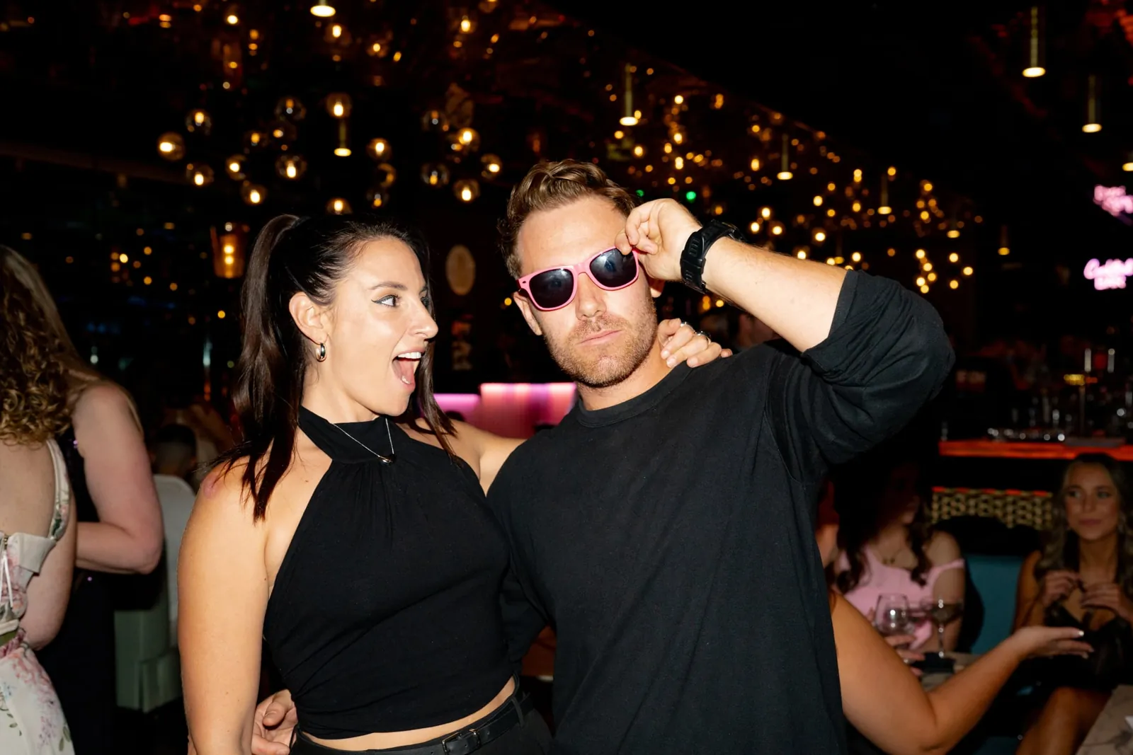 Two guests laughing and dancing at an evening event