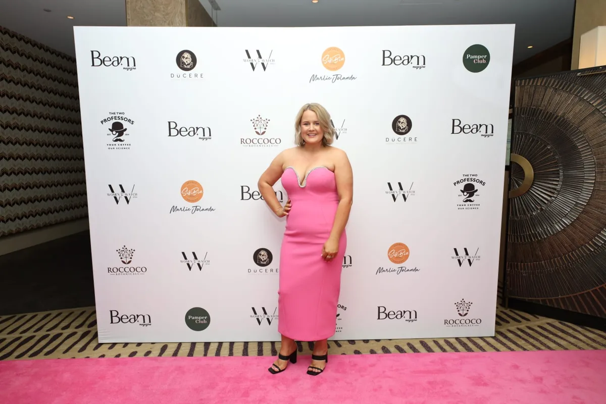 Beck Smith on the pink carpet in front of the Beam Magazine Women to Watch 2022 media wall in Brisbane