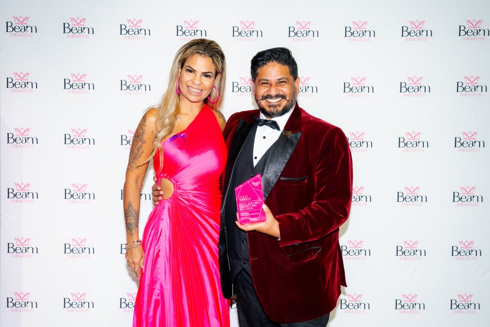 Two guests with an award at a previous BEAM Awards event
